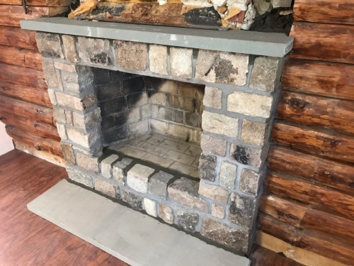 Cut granite and bluestone fireplace