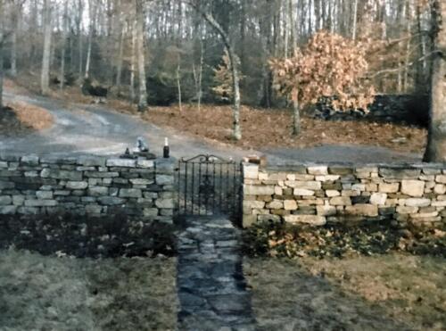 Double Faced Fieldstone Entrance with Iron Gate