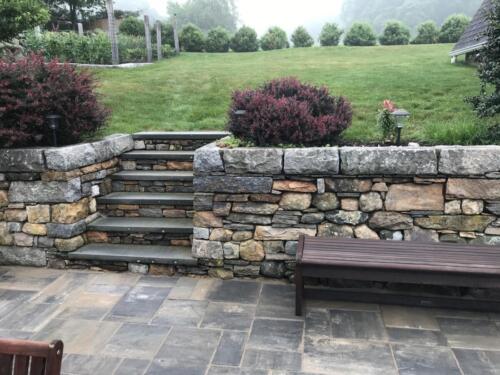 Fieldstone Wall Topped with Cut Granite and Fieldstone Steps Topped with Bluestone.