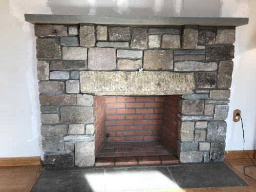 Cut granite and brick fireplace