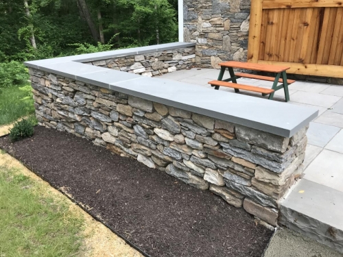 Bluestone patio with a field stone border topped with bluestone