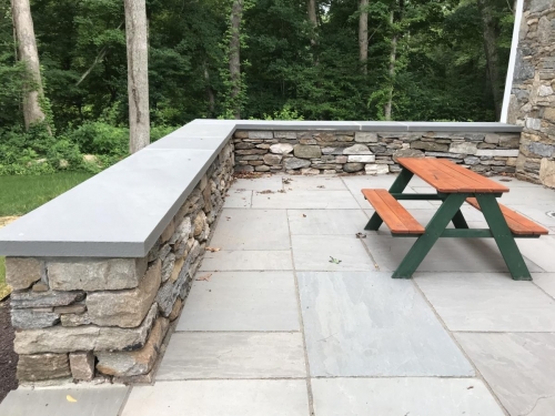 Bluestone patio with a field stone border topped with bluestone