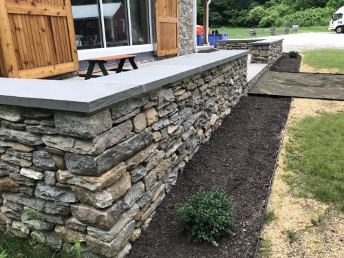 Bluestone patio with a field stone border topped with bluestone