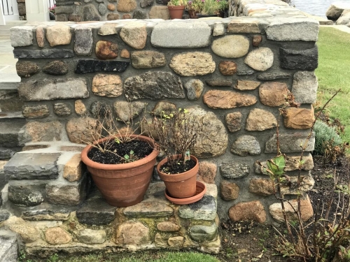 Beach stone and fieldstone sitting wall