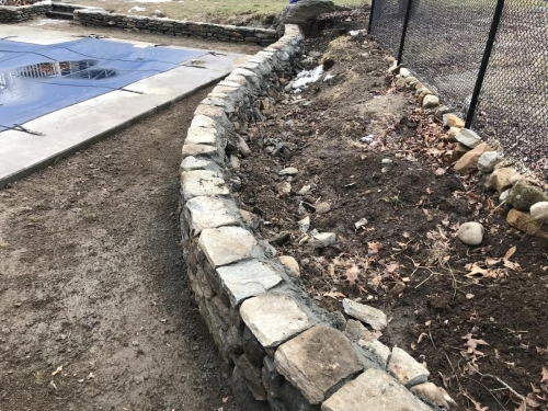 Low fieldstone retaining walls