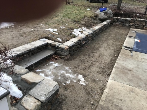 Low fieldstone retaining walls and steps