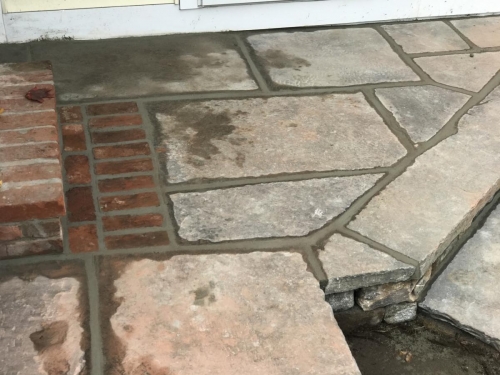 Fieldstone base capped with old bluestone with antique granite edging