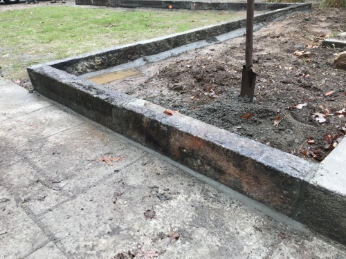Fieldstone base capped with old bluestone with antique granite edging