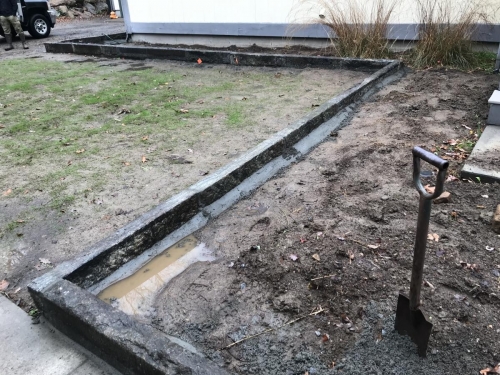 Fieldstone base capped with old bluestone with antique granite edging
