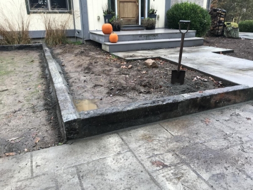 Fieldstone base capped with old bluestone with antique granite edging